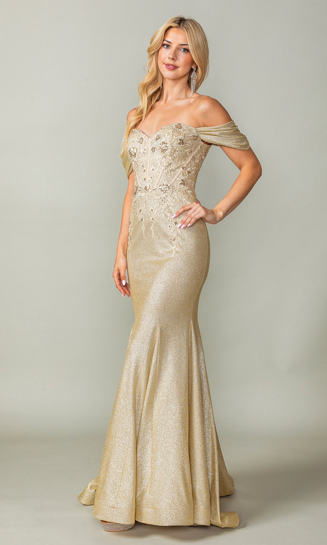 A woman stands gracefully against a plain background, wearing the Off-Shoulder Long Prom Dress: Dancing Queen 4362, featuring a shimmering glitter print and intricate embroidery.